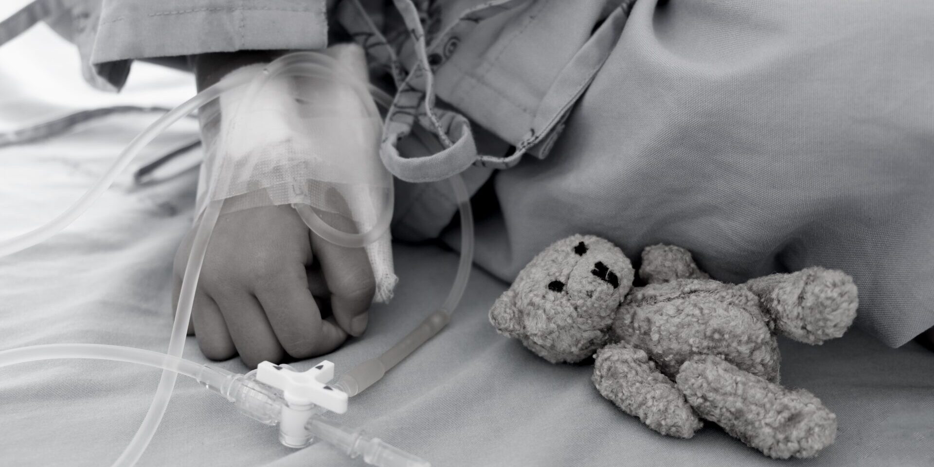 Mother holding child's hand who fever patients in hospital to give encouragement.